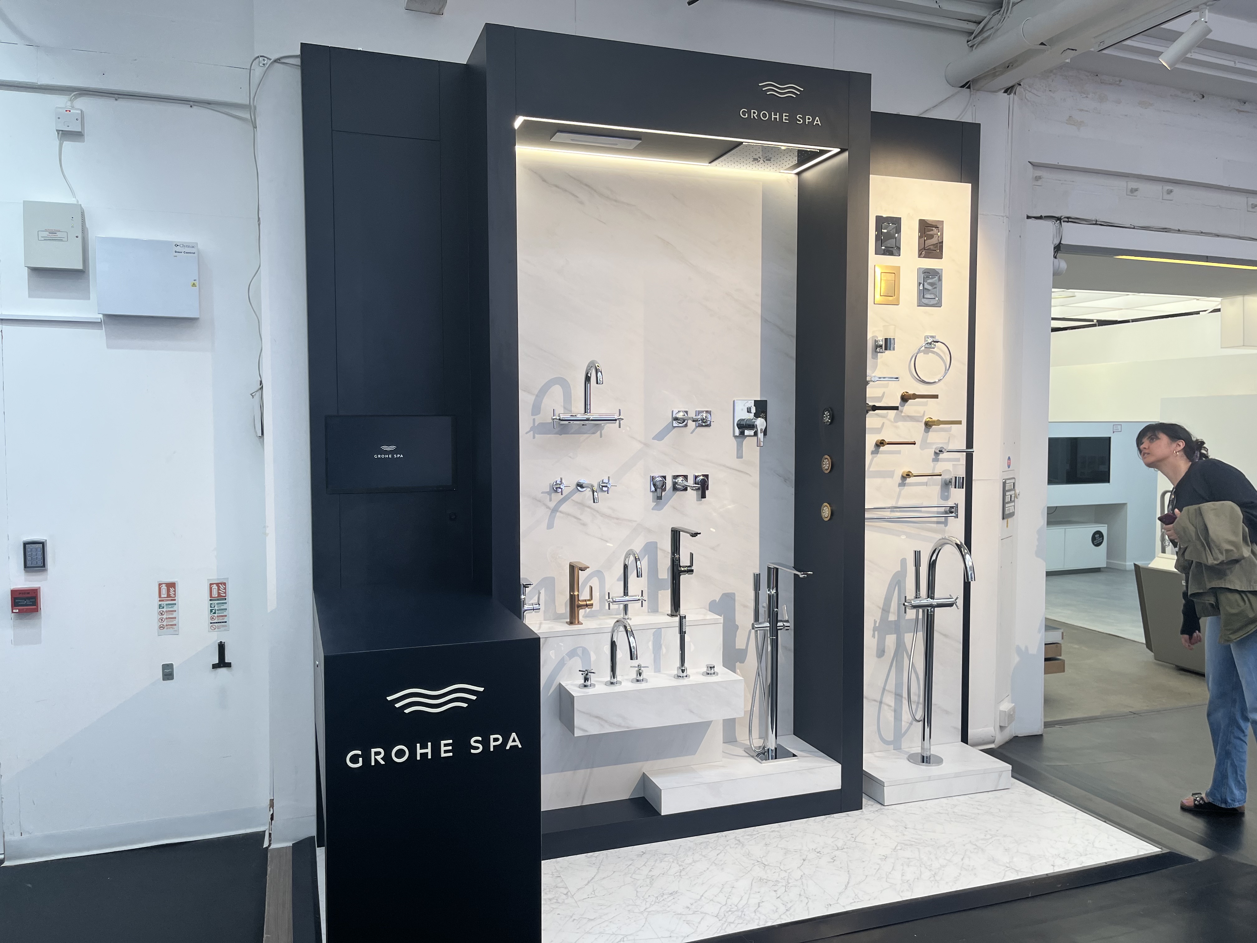 Grohe Spa premium tap display being installed in trade showroom with marble and matte black finishes